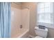 Bathroom with a combined shower and tub, accompanied by a window for natural light at 3906 Elm Trace Ct, Loganville, GA 30052
