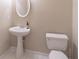 A half bathroom with a pedestal sink and white toilet at 3906 Elm Trace Ct, Loganville, GA 30052