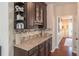 Butler's pantry with custom cabinetry, granite countertops, and stylish mosaic backsplash at 3906 Elm Trace Ct, Loganville, GA 30052