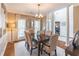 Elegant dining room featuring a wood table, upholstered chairs, and a stylish chandelier at 3906 Elm Trace Ct, Loganville, GA 30052