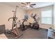 Home exercise room equipped with workout equipment, including a stationary bike and elliptical machine at 3906 Elm Trace Ct, Loganville, GA 30052
