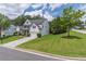 A Beautiful two-story home showcasing its well-maintained lawn and a long driveway at 3906 Elm Trace Ct, Loganville, GA 30052
