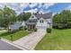 Two story traditional home boasting a well-manicured lawn and long driveway at 3906 Elm Trace Ct, Loganville, GA 30052