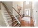 Grand foyer featuring a staircase, hardwood floors, and an abundance of natural light at 3906 Elm Trace Ct, Loganville, GA 30052