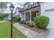 The inviting front entrance features a brick porch and meticulously landscaped surroundings at 3906 Elm Trace Ct, Loganville, GA 30052