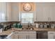 A kitchen featuring a mosaic backsplash, granite countertops, stainless steel appliances, and ample cabinetry at 3906 Elm Trace Ct, Loganville, GA 30052