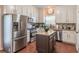 Modern kitchen with stainless steel appliances, granite countertops, and center island at 3906 Elm Trace Ct, Loganville, GA 30052