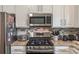 A kitchen featuring stainless steel appliances and white cabinets at 3906 Elm Trace Ct, Loganville, GA 30052