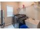 Functional laundry room with modern washer and dryer and a utility sink at 3906 Elm Trace Ct, Loganville, GA 30052