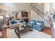 Spacious living room with open staircase, hardwood floors, and bright windows at 3906 Elm Trace Ct, Loganville, GA 30052