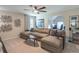 Comfortable living room featuring a large sectional sofa, ceiling fan, and stylish decor at 3906 Elm Trace Ct, Loganville, GA 30052