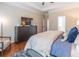 Spacious main bedroom with hardwood floors, chest of drawers, and decor at 3906 Elm Trace Ct, Loganville, GA 30052
