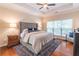 Spacious main bedroom with hardwood floors, tray ceiling, and large window at 3906 Elm Trace Ct, Loganville, GA 30052