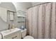 Bathroom with a modern vanity and a shower featuring a seashell-themed curtain at 4204 Woodfare Nw Ln, Kennesaw, GA 30152