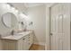 Bright bathroom featuring double vanity with granite countertops, and warm lighting at 4204 Woodfare Nw Ln, Kennesaw, GA 30152