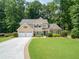 Charming two-story home with a well-manicured lawn and a two-car garage at 4204 Woodfare Nw Ln, Kennesaw, GA 30152