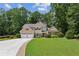 Charming home with a well-manicured lawn, lush landscaping, and a two-car garage at 4204 Woodfare Nw Ln, Kennesaw, GA 30152