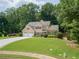Beautiful home featuring a well-maintained lawn, mature trees, and a two-car garage at 4204 Woodfare Nw Ln, Kennesaw, GA 30152