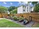 Fenced backyard garden featuring raised garden beds, gravel paths, and lush greenery at 4204 Woodfare Nw Ln, Kennesaw, GA 30152
