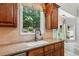 Close up of sink and granite counter tops with window view to back yard at 4204 Woodfare Nw Ln, Kennesaw, GA 30152