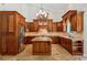 Well-appointed kitchen with wood cabinetry, a central island, stainless steel appliances and stylish lighting at 4204 Woodfare Nw Ln, Kennesaw, GA 30152