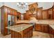 Gourmet kitchen featuring wood cabinets, granite countertops, island, and stainless-steel appliances at 4204 Woodfare Nw Ln, Kennesaw, GA 30152