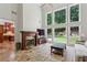 Living room with soaring ceilings, fireplace, and large windows overlooking backyard at 4204 Woodfare Nw Ln, Kennesaw, GA 30152