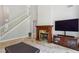 Spacious living room with fireplace, tall windows, and a view of the staircase at 4204 Woodfare Nw Ln, Kennesaw, GA 30152
