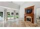 Comfortable living room featuring a fireplace, large windows with backyard views and tiled floors at 4204 Woodfare Nw Ln, Kennesaw, GA 30152