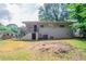 Exterior view of a home's backyard featuring a lawn and stair access to the home's back entrance at 1538 Belva Ave, Decatur, GA 30032