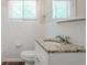 A charming bathroom featuring tile and a granite countertop at 1538 Belva Ave, Decatur, GA 30032