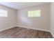 Bedroom with hardwood flooring, neutral paint, and two windows offering natural light at 1538 Belva Ave, Decatur, GA 30032