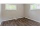 Bedroom with hardwood flooring, neutral paint, and two windows offering natural light at 1538 Belva Ave, Decatur, GA 30032