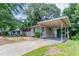 View of home with carport, driveway, and landscaping at 1538 Belva Ave, Decatur, GA 30032