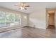 Bright living room with large window, hardwood floors, and modern ceiling fan at 1538 Belva Ave, Decatur, GA 30032
