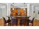 Elegant home bar featuring wood cabinetry, granite countertops, and seating for entertaining guests at 1589 Trentwood Ne Pl, Brookhaven, GA 30319
