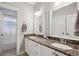 Well-lit bathroom features granite countertops, double sinks, and white cabinetry at 1589 Trentwood Ne Pl, Brookhaven, GA 30319