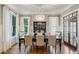 Formal dining room boasts a chandelier, display cabinet, and views to the exterior at 1589 Trentwood Ne Pl, Brookhaven, GA 30319