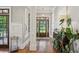 Bright foyer featuring hardwood floors, a decorative light fixture, and views of the front yard at 1589 Trentwood Ne Pl, Brookhaven, GA 30319