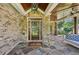 Inviting front porch with stone accents, a porch swing and ceiling fans at 1589 Trentwood Ne Pl, Brookhaven, GA 30319
