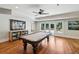 Well-lit game room features a pool table and access to the outdoor patio area at 1589 Trentwood Ne Pl, Brookhaven, GA 30319