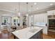 Open-concept kitchen with quartz countertops, a center island, and stainless steel refrigerator at 1589 Trentwood Ne Pl, Brookhaven, GA 30319