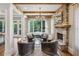 Cozy living room with stone fireplace, exposed beams, and lots of natural light at 1589 Trentwood Ne Pl, Brookhaven, GA 30319