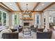 Inviting living room featuring a stone fireplace, comfortable seating, and bright windows at 1589 Trentwood Ne Pl, Brookhaven, GA 30319