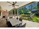 Charming covered patio with ample seating, a dining table, and views of the landscaped backyard at 1589 Trentwood Ne Pl, Brookhaven, GA 30319