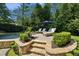 Beautiful pool and stone patio area with lounge chairs and umbrella offer a relaxing outdoor space at 1589 Trentwood Ne Pl, Brookhaven, GA 30319