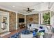 Cozy screened-in porch with brick wall, comfortable seating and outdoor ceiling fan, for relaxing with nature at 1589 Trentwood Ne Pl, Brookhaven, GA 30319