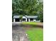 Charming single-story home with a black-trimmed garage and black-framed windows, surrounded by lush greenery at 168 Park Ln, Dallas, GA 30157