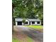 Charming single-story home with a black-trimmed garage and black-framed windows, surrounded by lush greenery at 168 Park Ln, Dallas, GA 30157