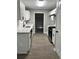 Updated kitchen features gray walls, white cabinets, stainless steel appliances and modern black hardware at 168 Park Ln, Dallas, GA 30157